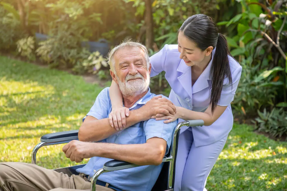 Happy nurse holding elderly